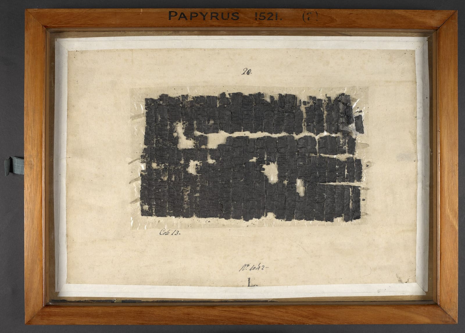 Charred Herculaneum papyrus 1521 in a frame at the British Library