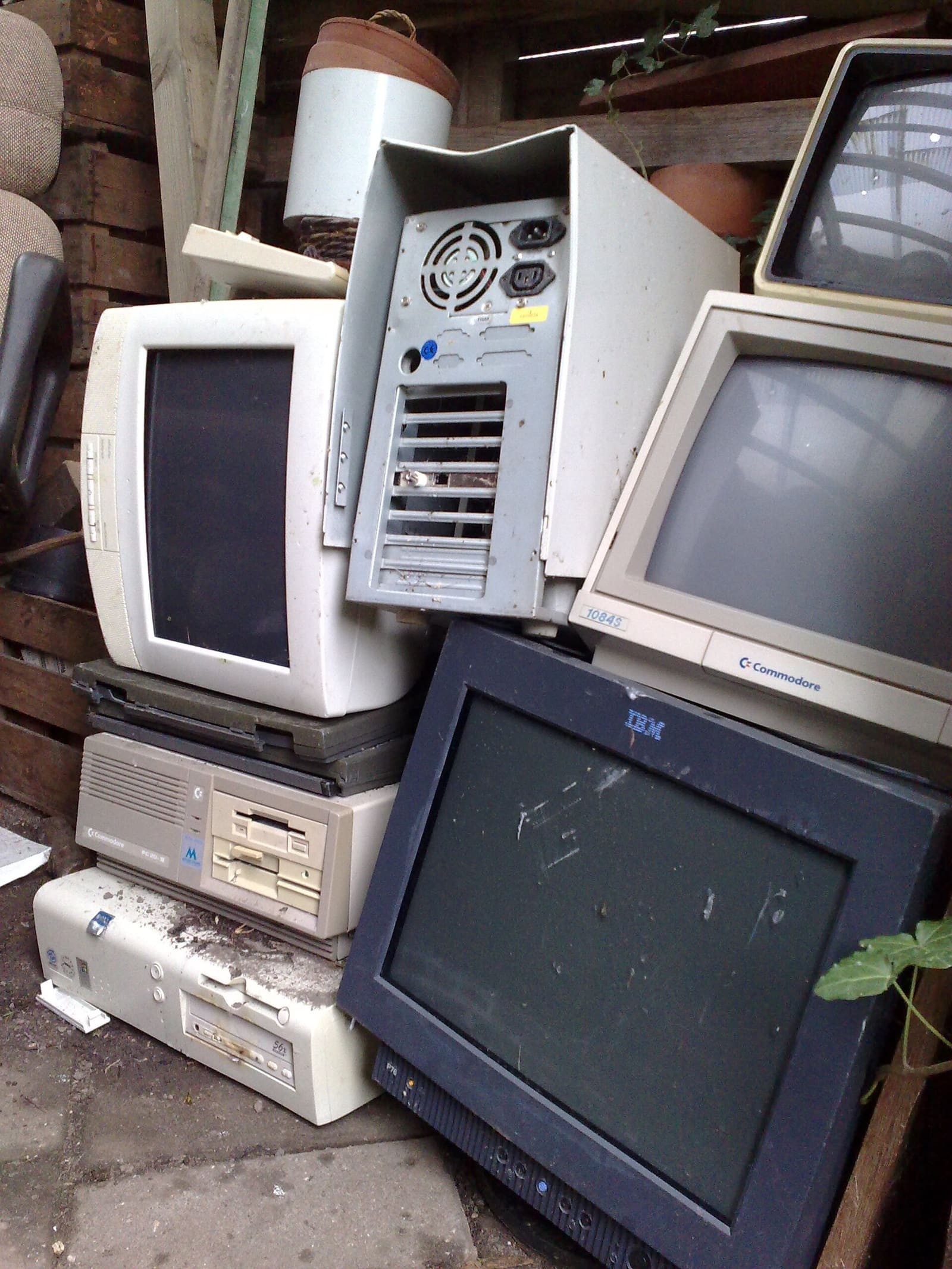 A pile of discarded computers and monitors