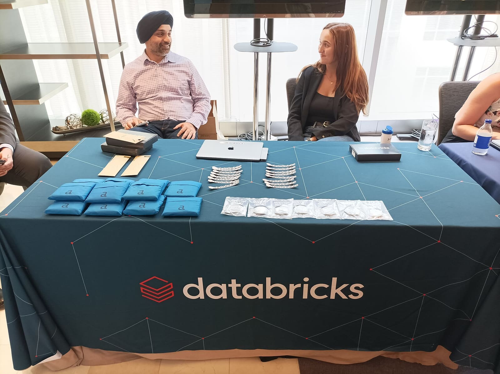 A Databricks booth with a branded table at a technology event