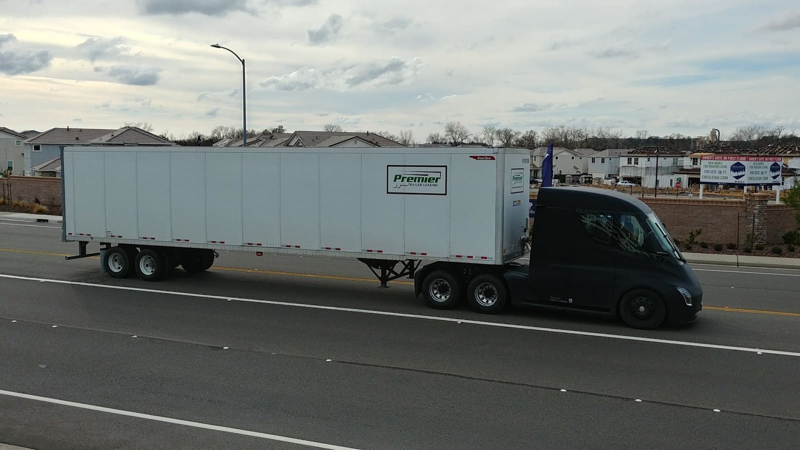 A white Tesla Semi electric truck cab parked outdoors