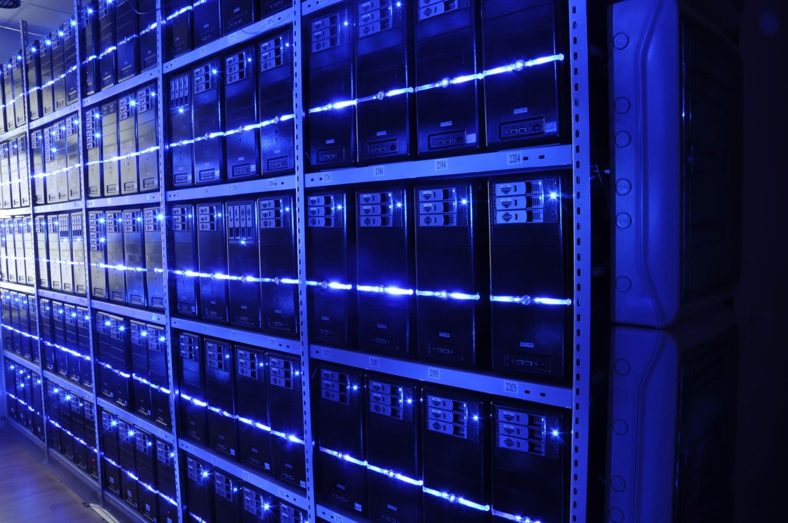A long aisle between server racks in a data center
