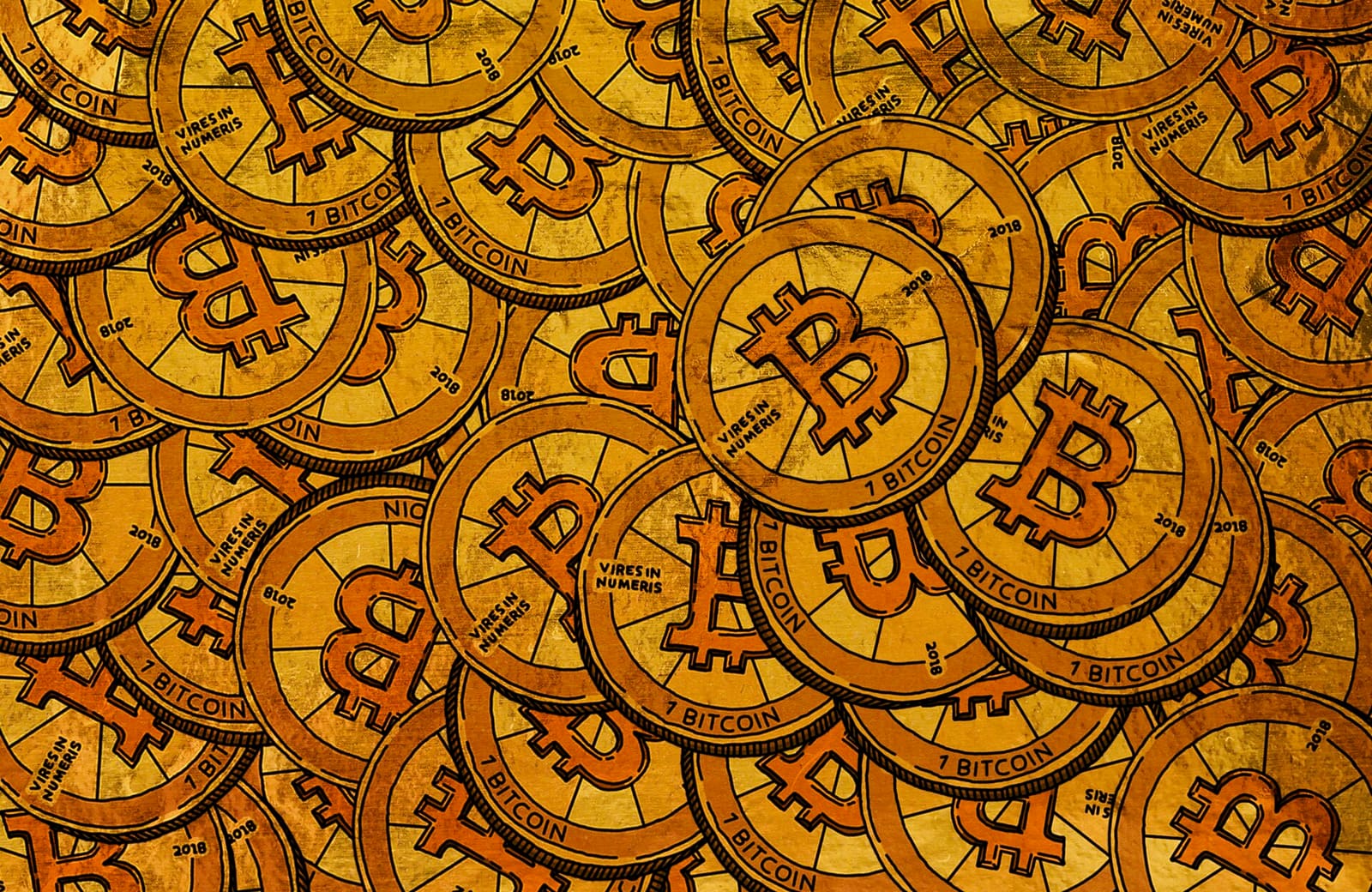 Physical coins with cryptocurrency logos on a table