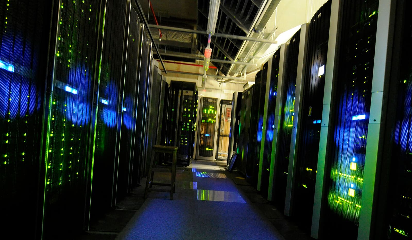Rows of server racks in a data center with raised flooring