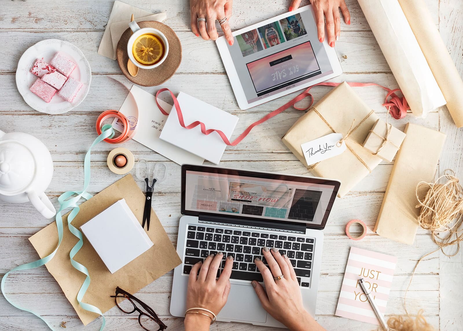 A person with a laptop and a credit card, shopping online