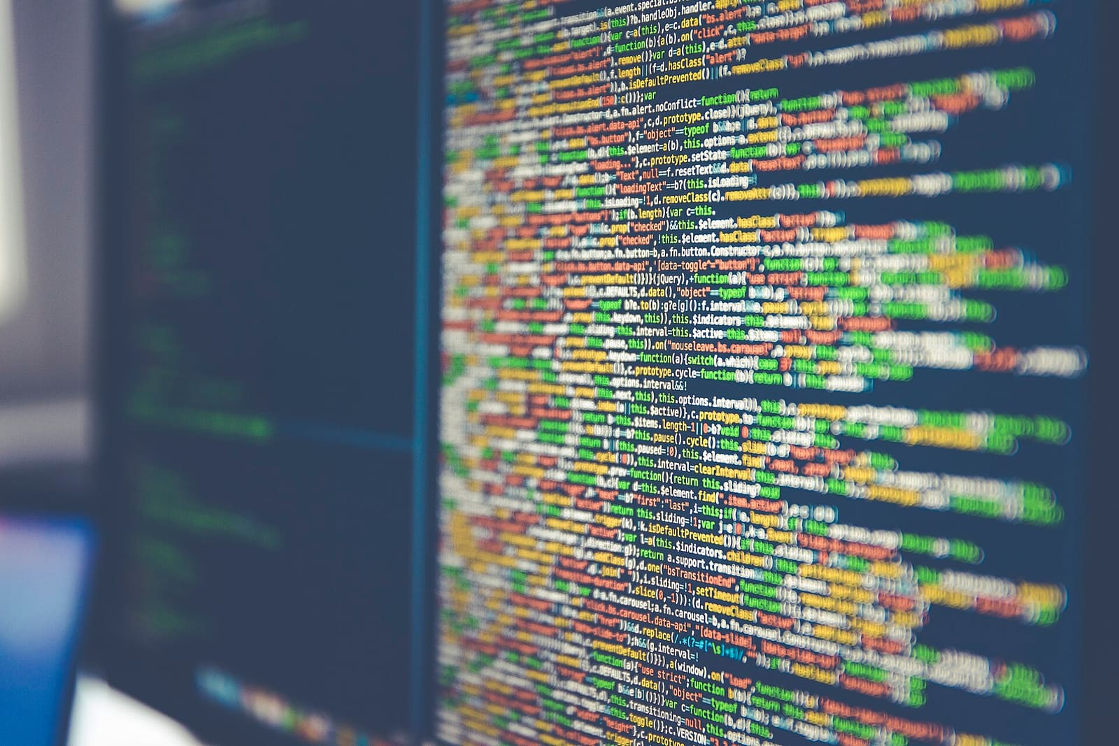 Lines of code on a computer monitor, out of focus at the edges