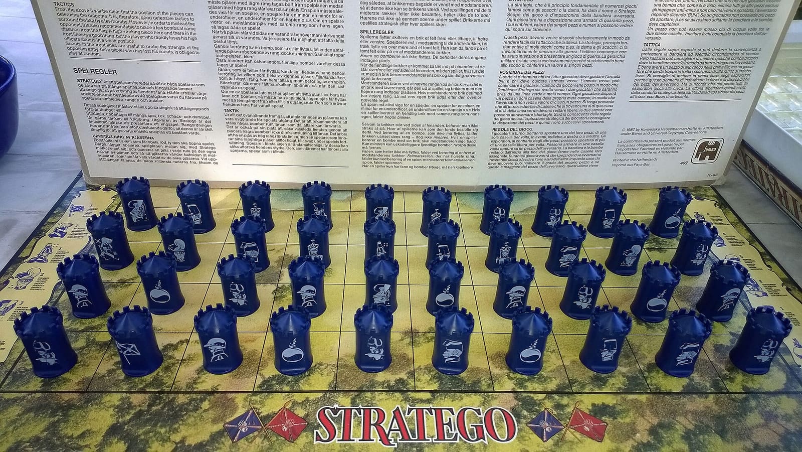 Blue Stratego pieces set up on the game board, their ranks hidden from the opponent