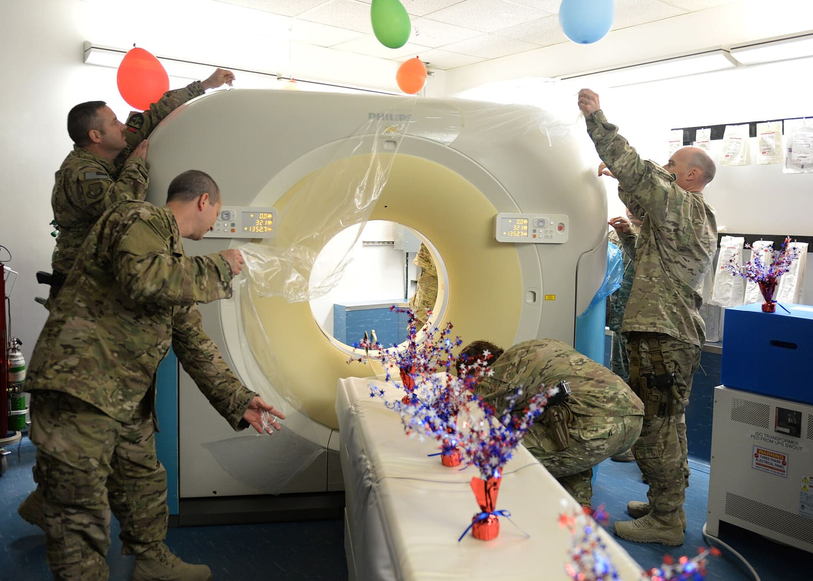 Hospital staff unwrapping a new CT scanner