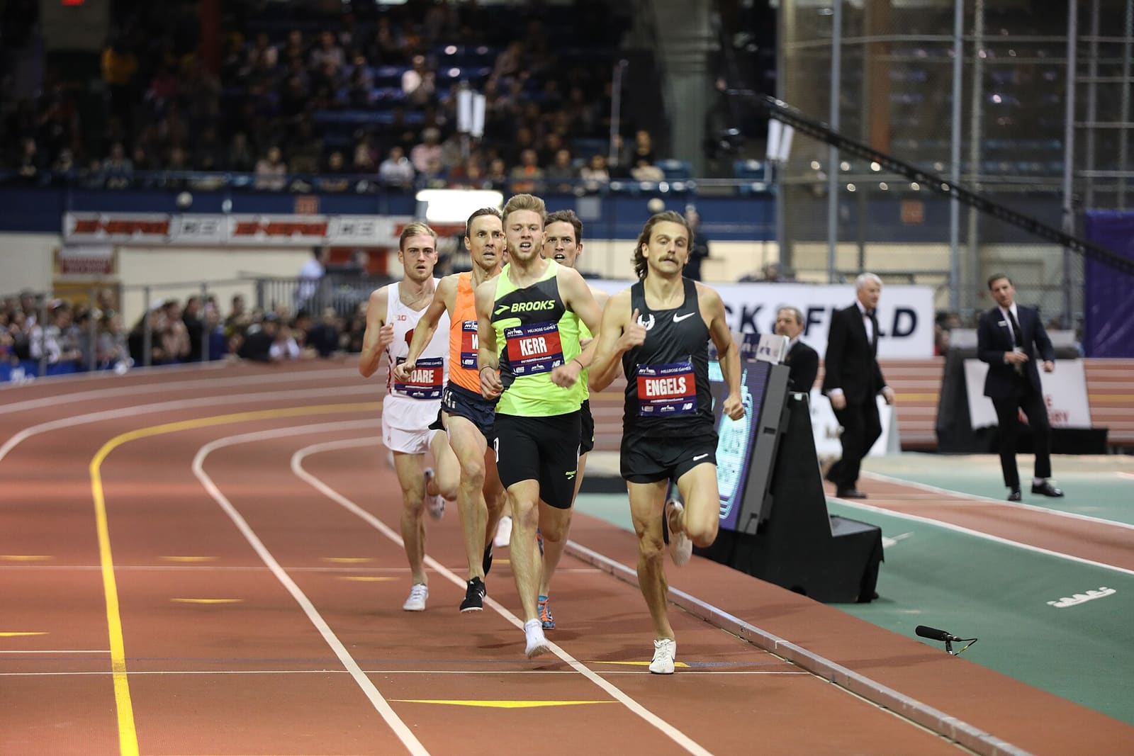Runners racing on an indoor track at the 2019 Millrose Games