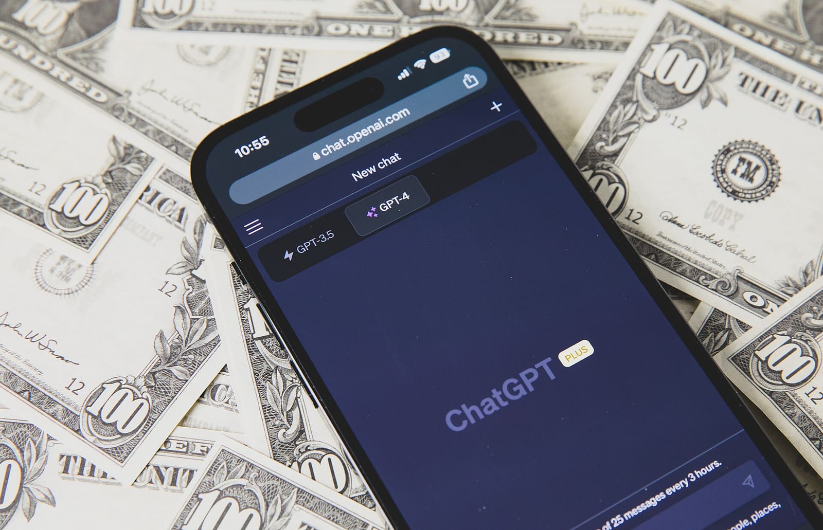 A smartphone showing ChatGPT lying on US dollar banknotes