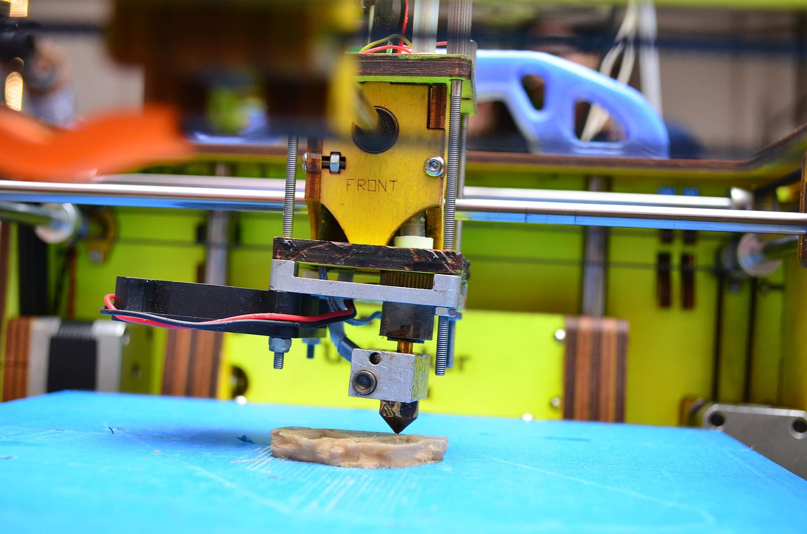 The print head of a 3D printer laying down the first layers of an object